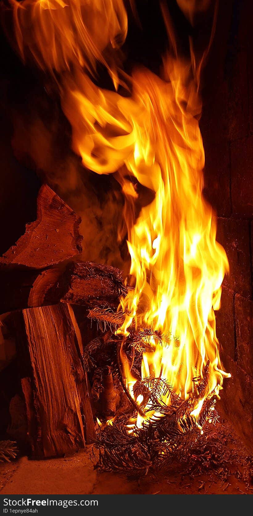 background bonfire from branches in the fireplace . flame sparks of fire on a black background burning bonfires on a dark background