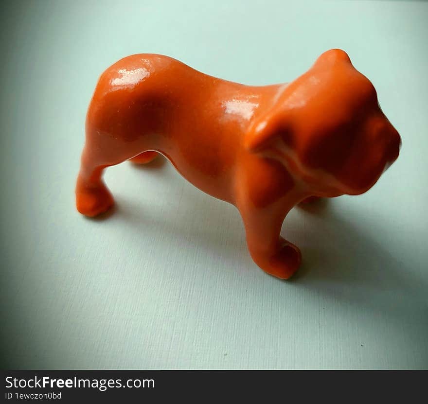 Ceramic Orange Bulldog Figurine On White Background