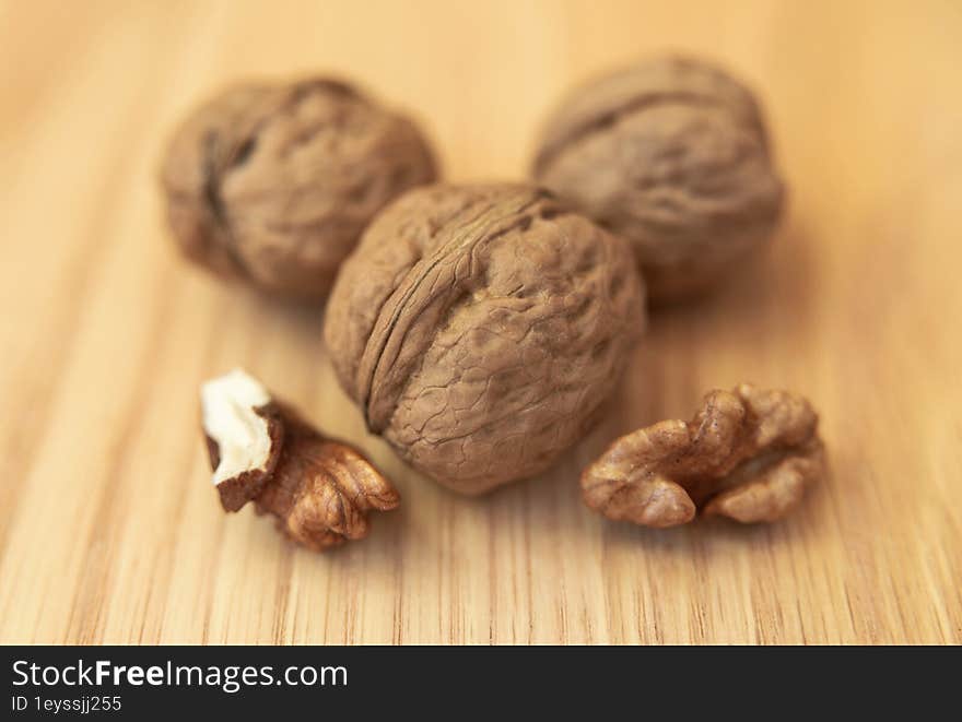 Whole Walnuts And Peeled Kernels On A Wooden Surface. Food And Drink