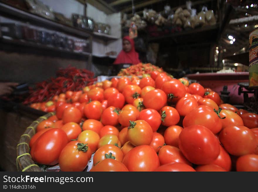 Piles of tomatoes for sale in a traditional market