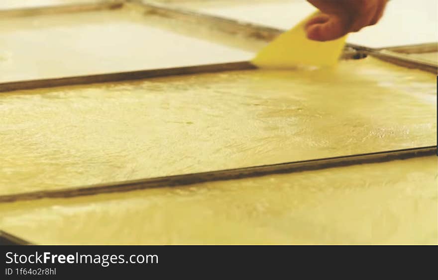 the process of cutting the coagulated soybean juice in the tray for making beancurd