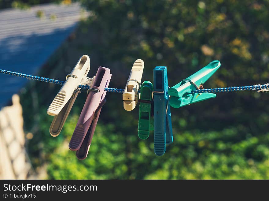 clothespins on a rope in the yard on a sunny day