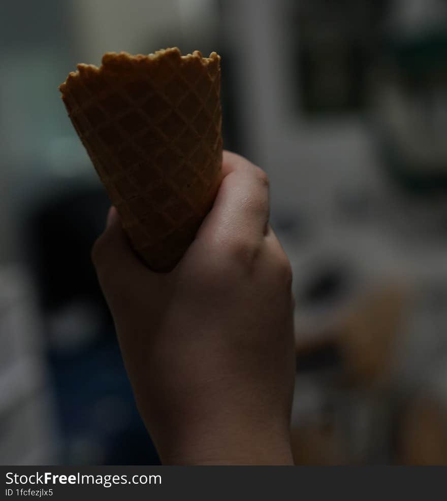 Hand hold ice cream cone ,close up