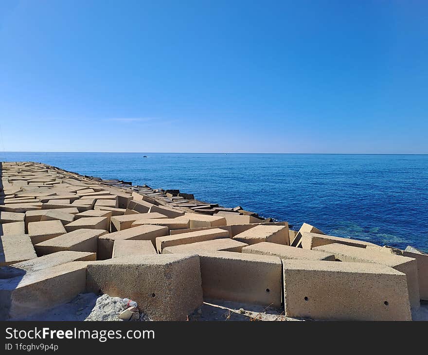 Breakwater and calm blue sea