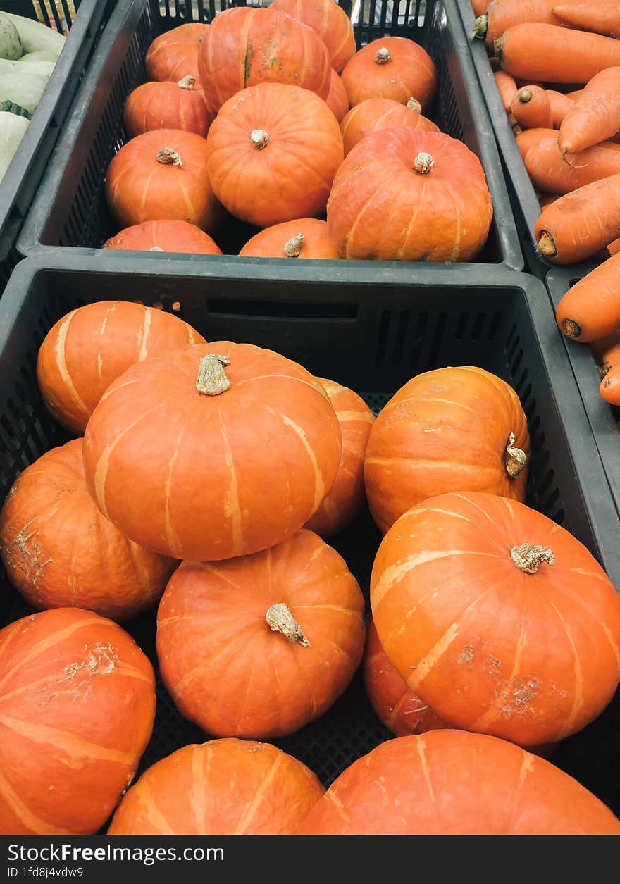 Pumpkins & x28 Red kuri squash  Hokkaido& x29  in a box at the market