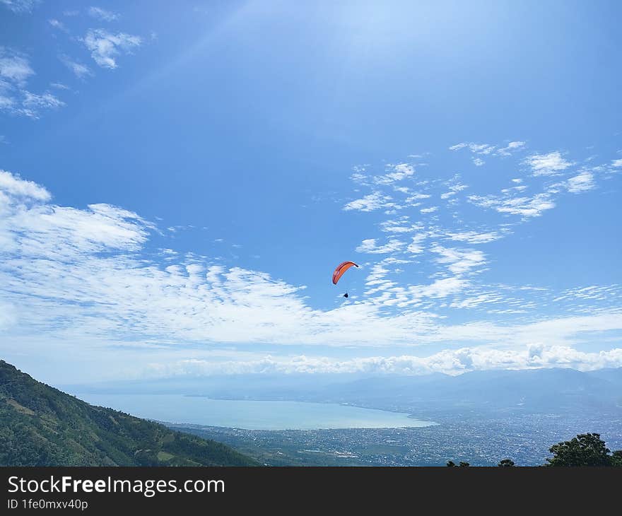 Living life on the edge, with the vast blue horizon below � paragliding, where the earth meets the heavens