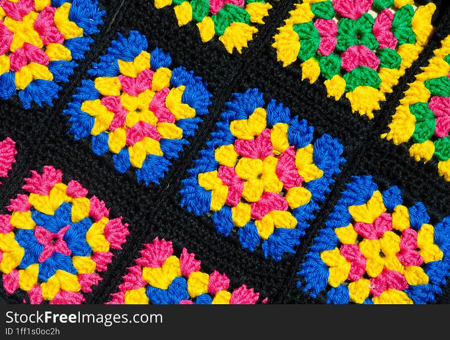 Colorful cotton granny square. Crochet texture close up photo. Knitted zigzag handmade jewelry