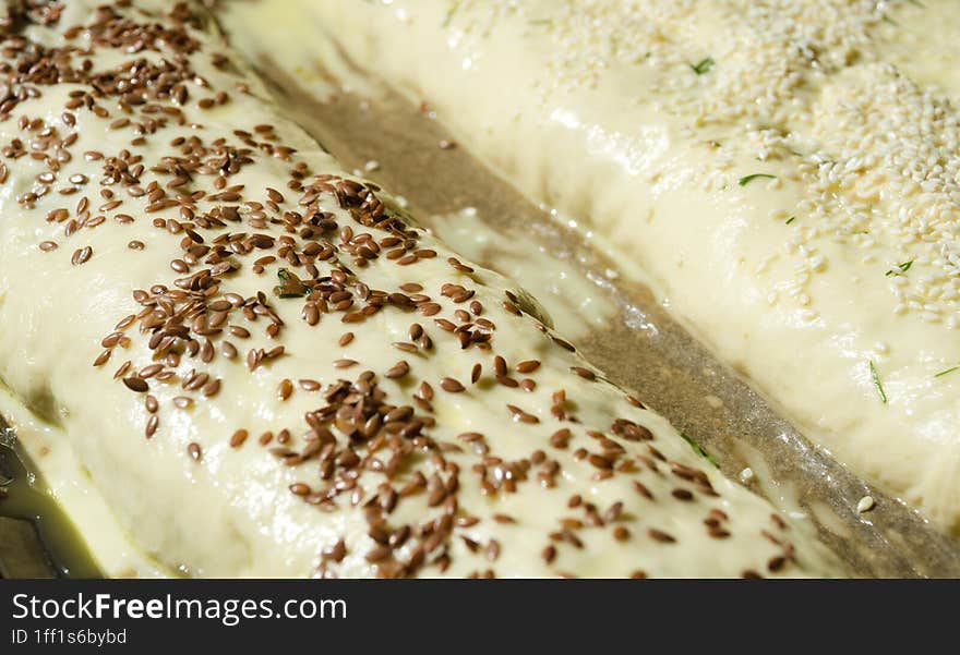 Meatloaf Made From Yeast Dough Sprinkled With Flax And Sesame Seeds On Parchment. Ready To Bake, Close-up, Macro