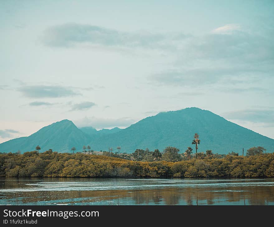 Beautiful View Of Mountains, Beaches And Clouds In The Background