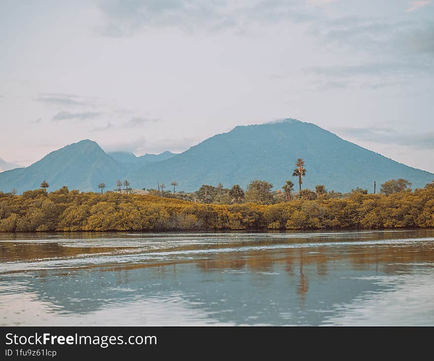 Beautiful view of mountains, beaches and clouds in the background. mountain reflection on the water