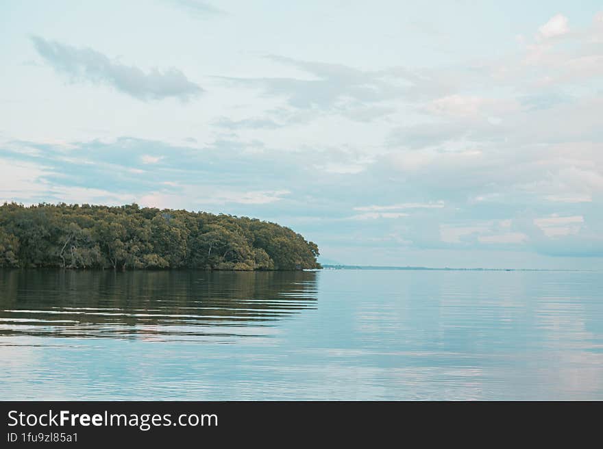 Beautiful View Of Clouds And Trees Reflecting On The Water. Beautiful Background