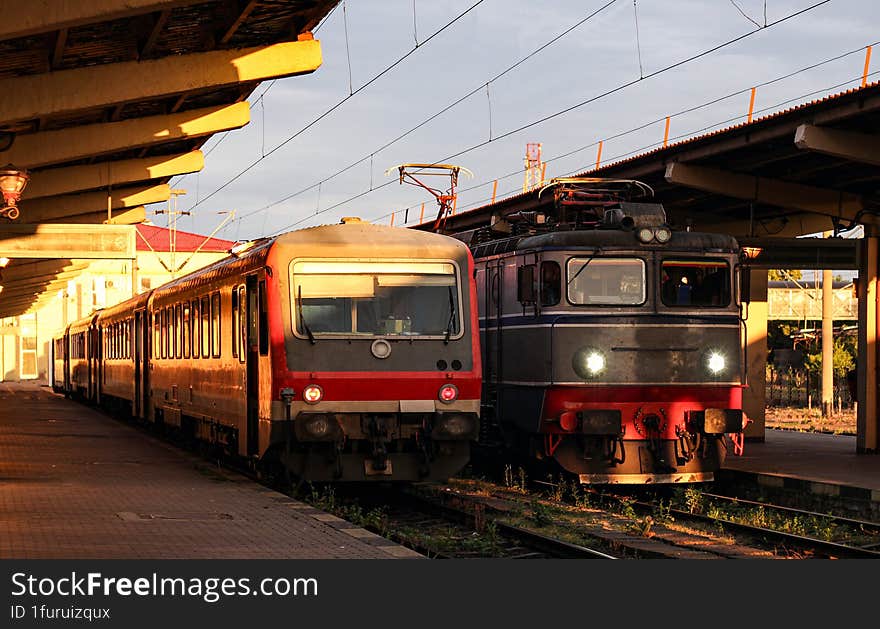 Romanian electric locomotive next to a private passenger train