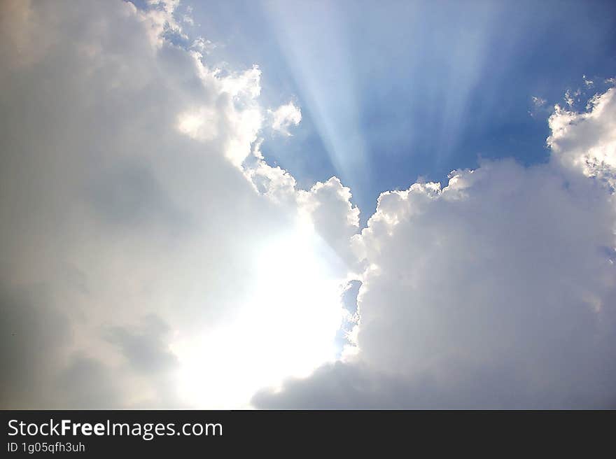 blue sky with white clouds and sun ray, nature cloudscape background