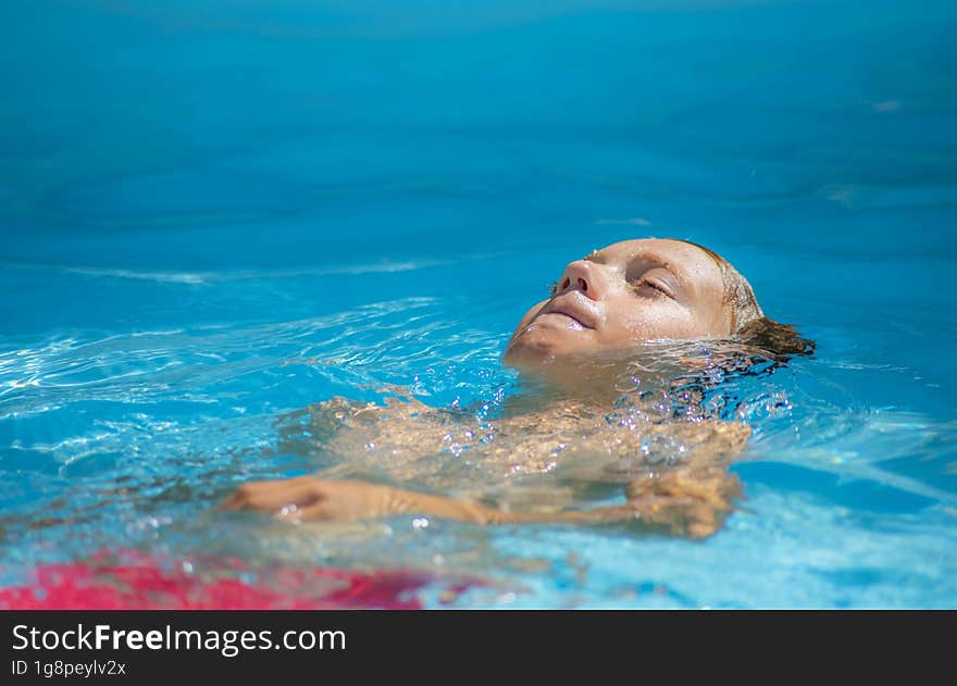 Young Boy Swimming In The Pool