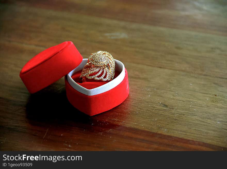 Close up  wedding rings in a red box on a wooden table