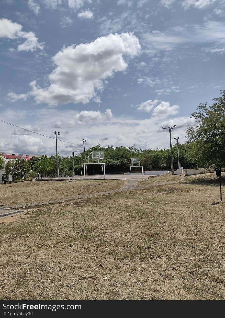 outdoor park with grass and blue sky with clouds