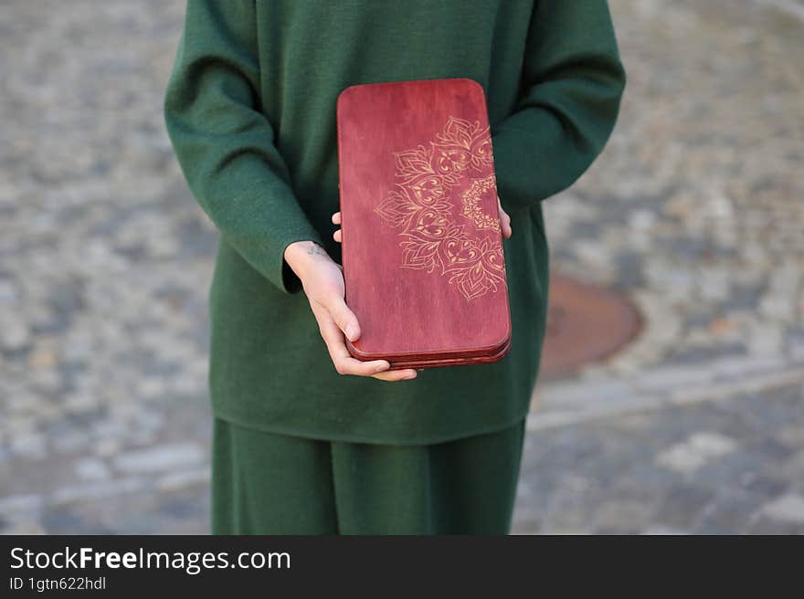 The girl is holding nailboards in her hands.