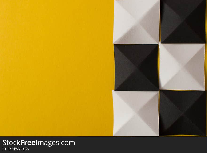 Black and white geometric shapes on yellow background with copy space