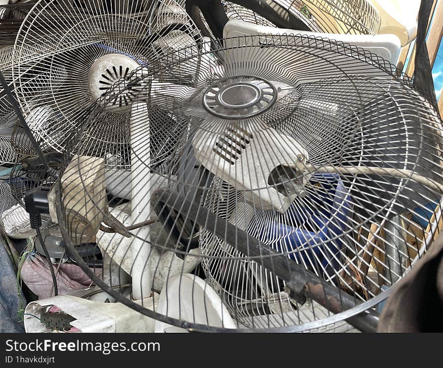 A pile of old fan frames at the electronics repair shop