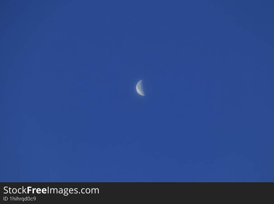 Moon in last quarter phase in dark blue clear sky