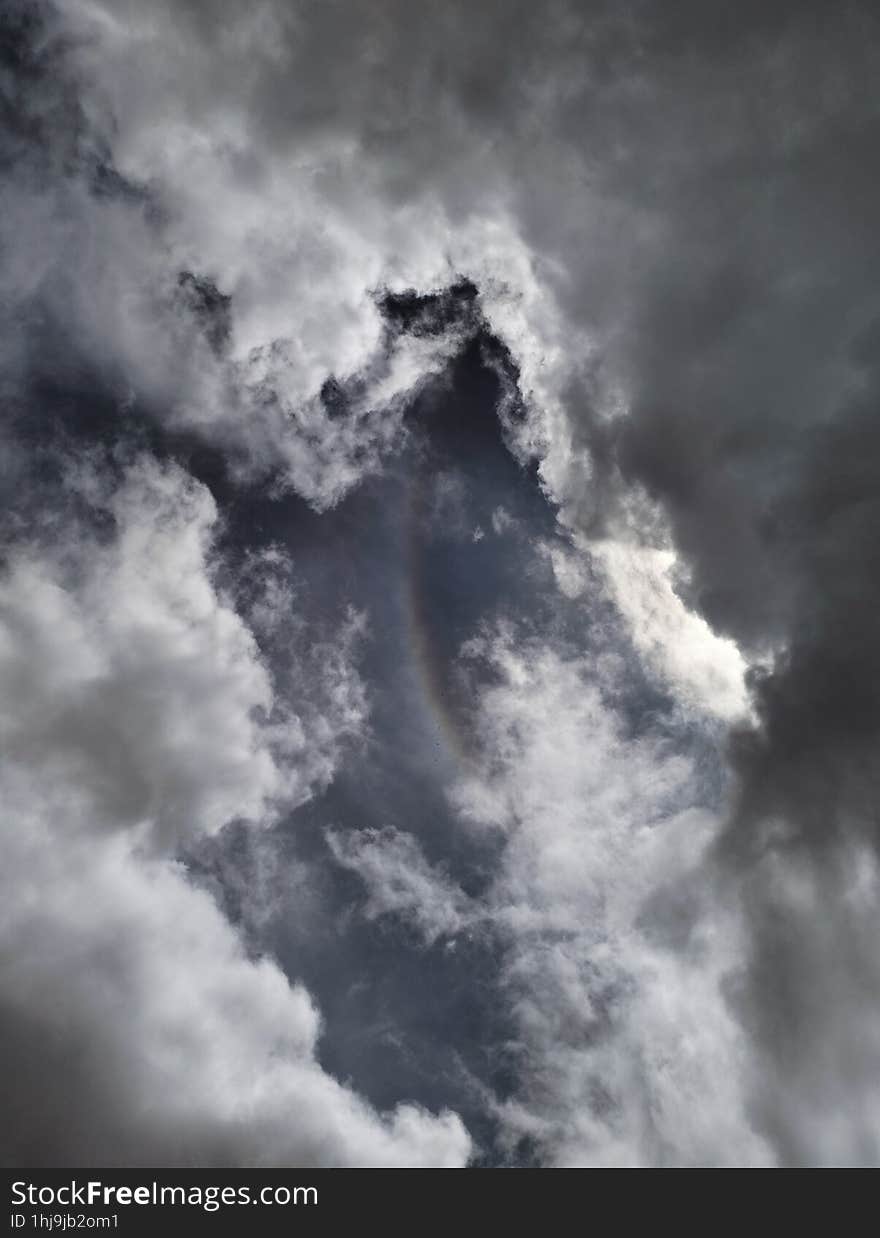 Rainbow And Circle Of Cloudy Clouds