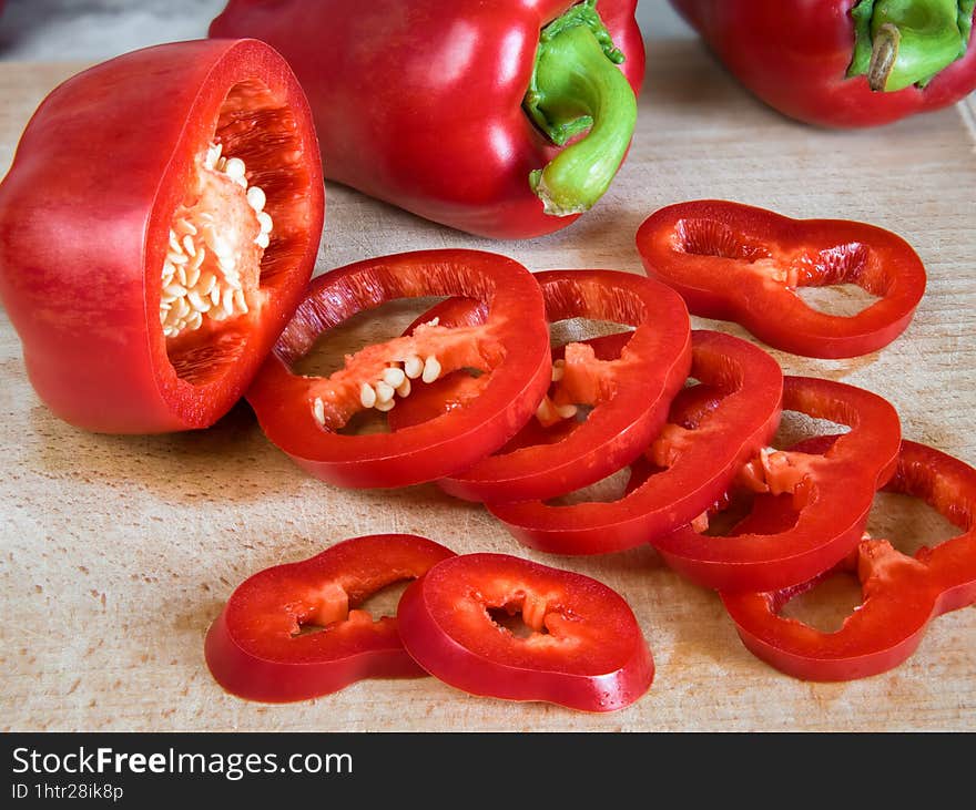 Slised red pepper & x28 paprika, capsicum& x29  on a beech cutting board