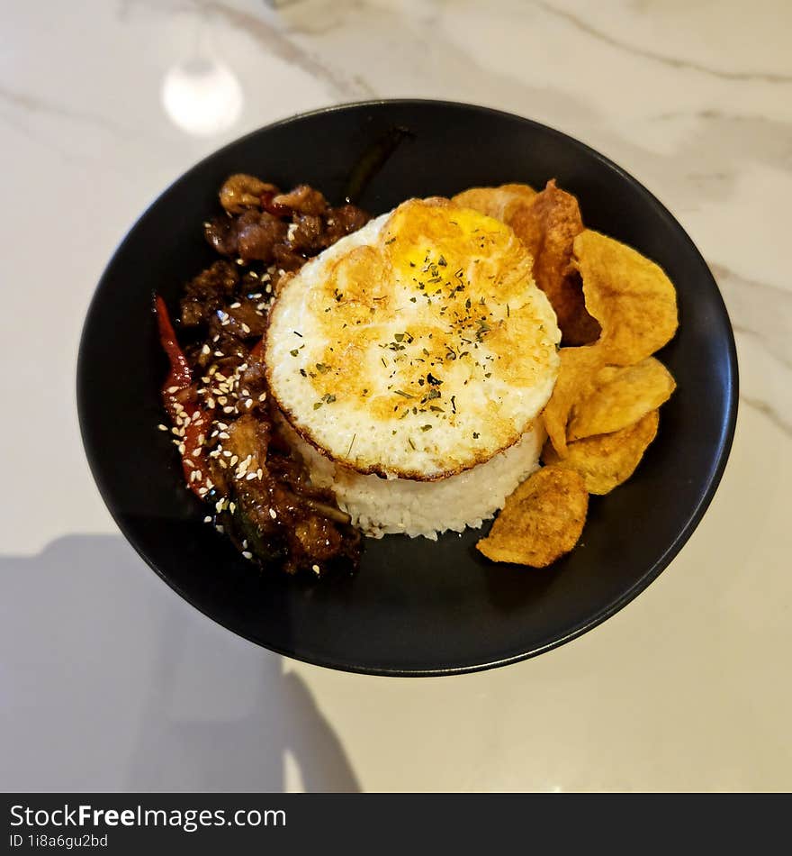 Beef Blackpepper Rice Bowl Dish With Fried Egg And Fried Potatoes