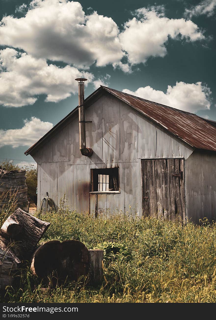 An old building surrounded by weeds