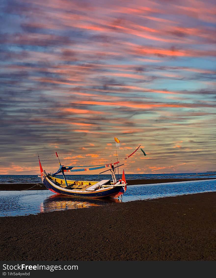 Boat in the beach and multy color cloud