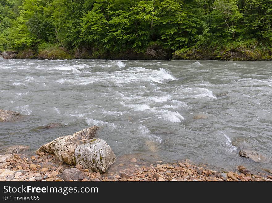 Mountain river spring season with sand and stone shoals along the banks