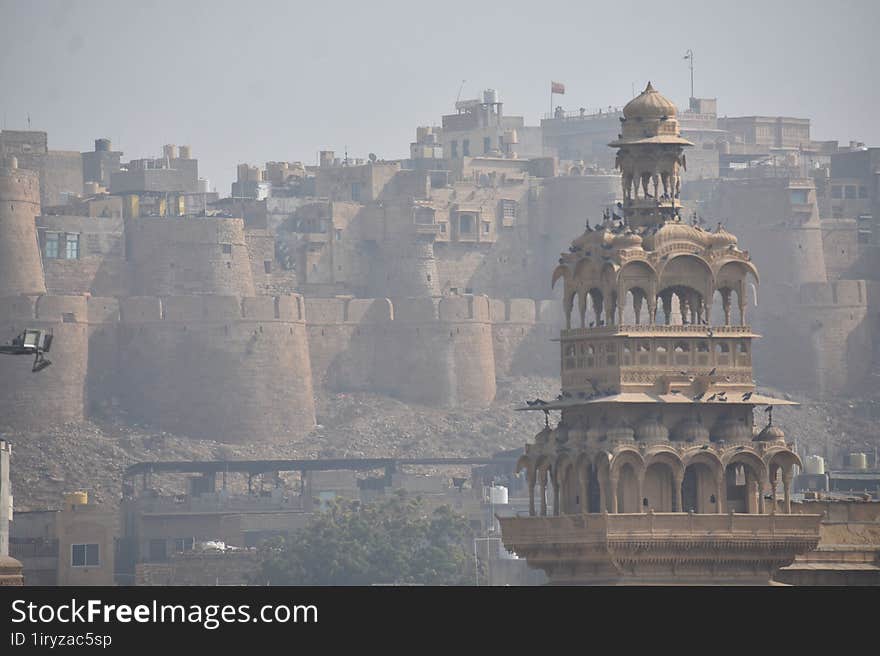 The image features a large stone building with a tower, set in a foggy outdoor setting. It is a historic site and a landmark, poss