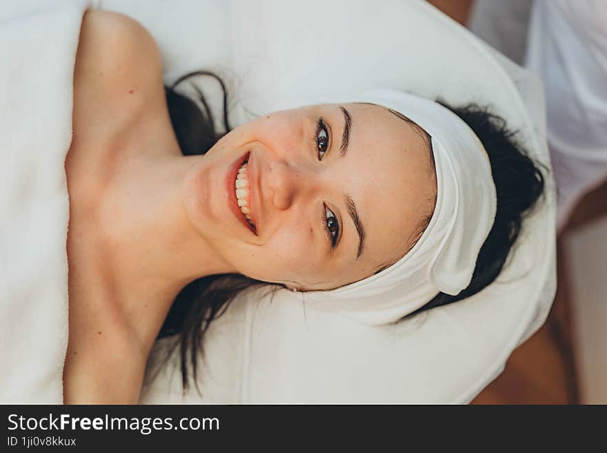 girl at a cosmetologist s office doing skin cleansing