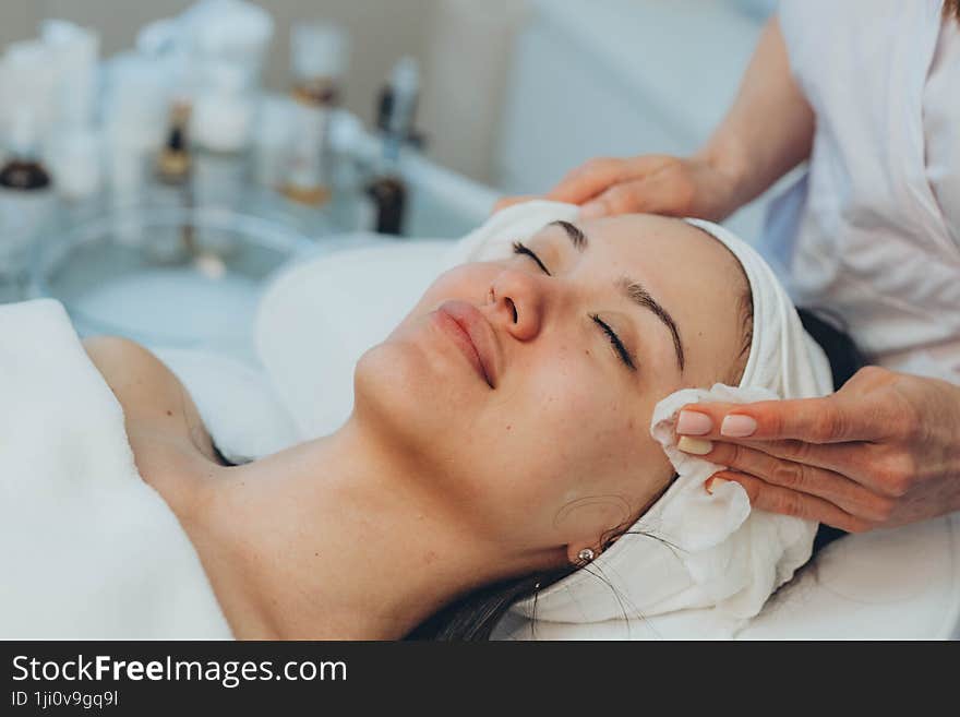 girl at a cosmetologist s office doing skin cleansing