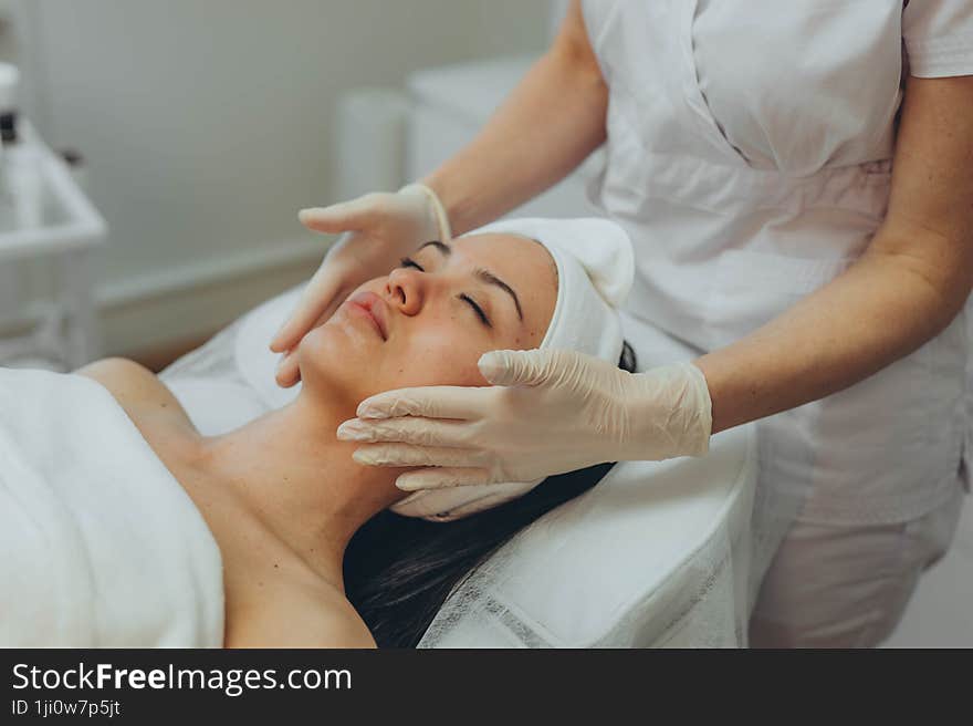 girl at a cosmetologist s office doing skin cleansing