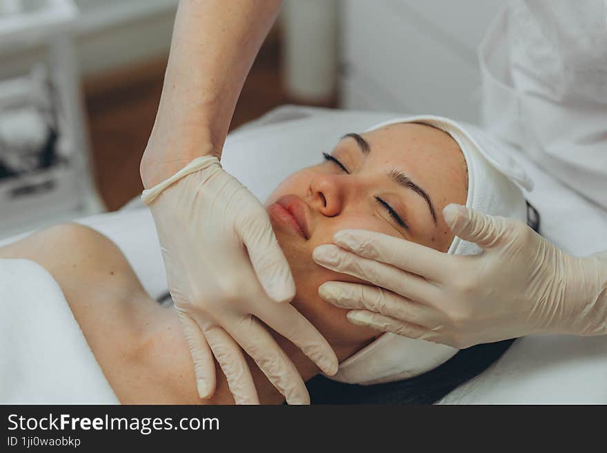 girl at a cosmetologist s office doing skin cleansing