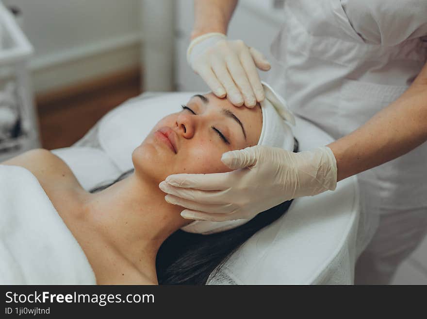 girl at a cosmetologist s office doing skin cleansing