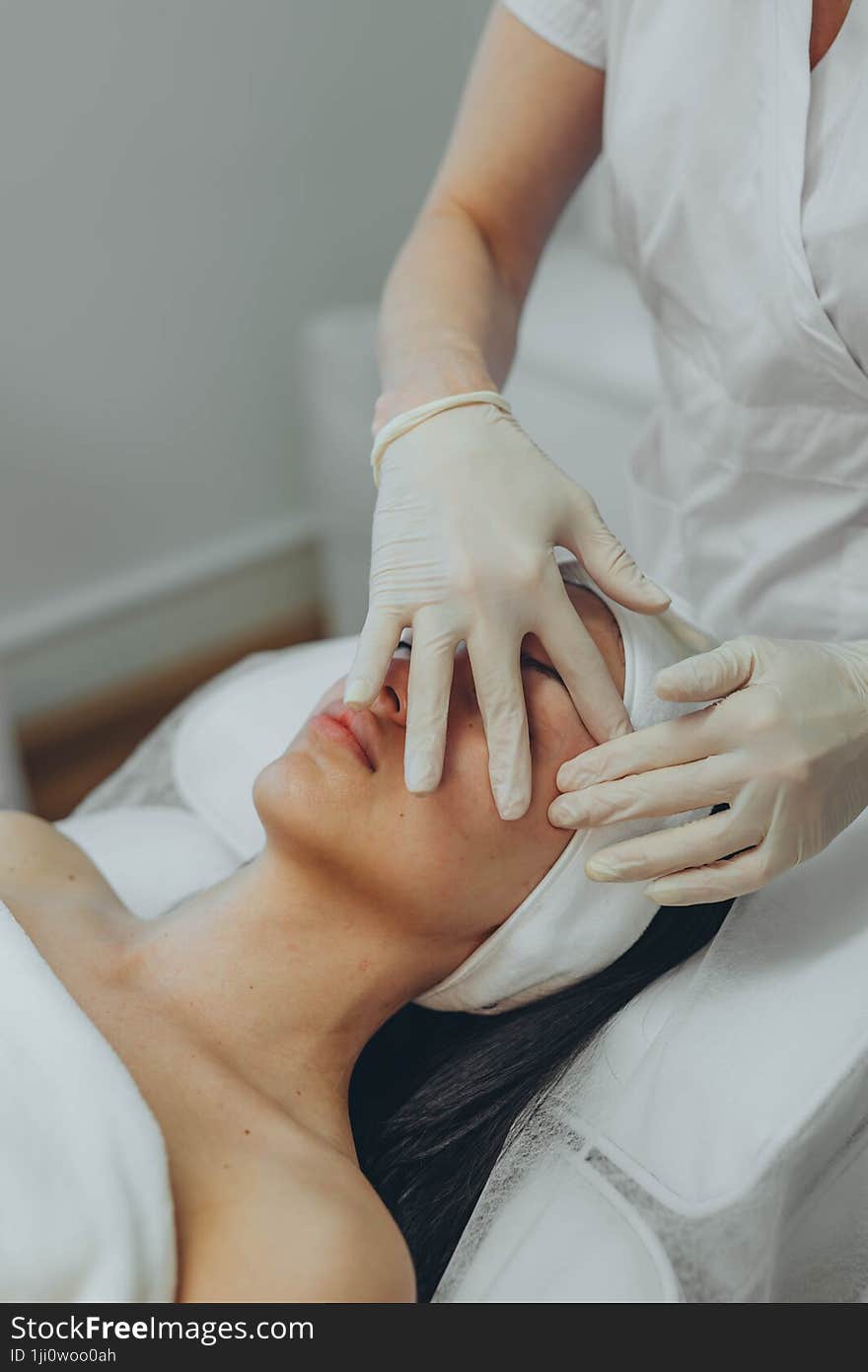 girl at a cosmetologist s office doing skin cleansing