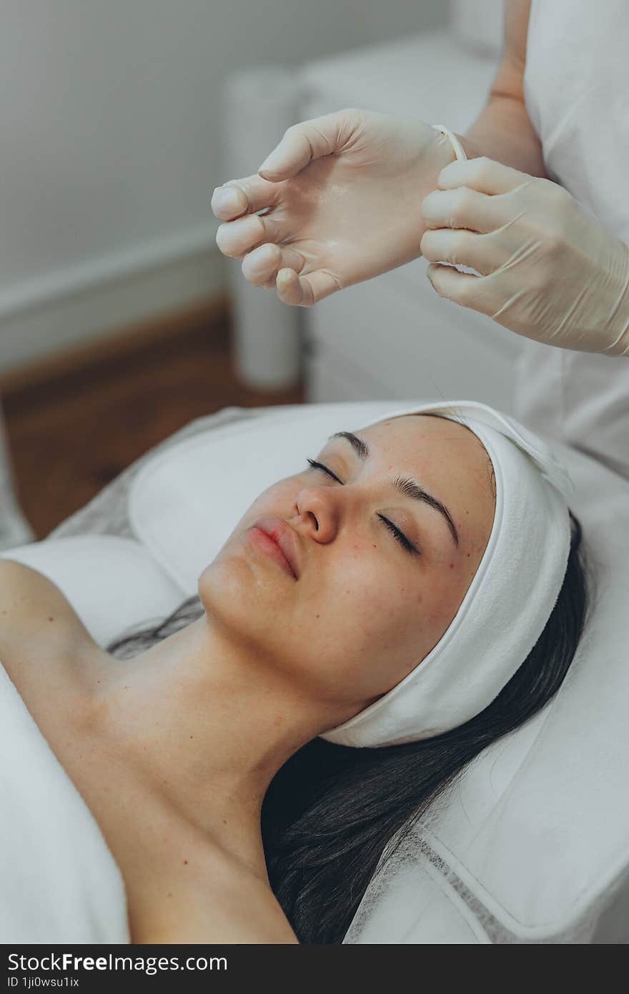 girl at a cosmetologist s office doing skin cleansing