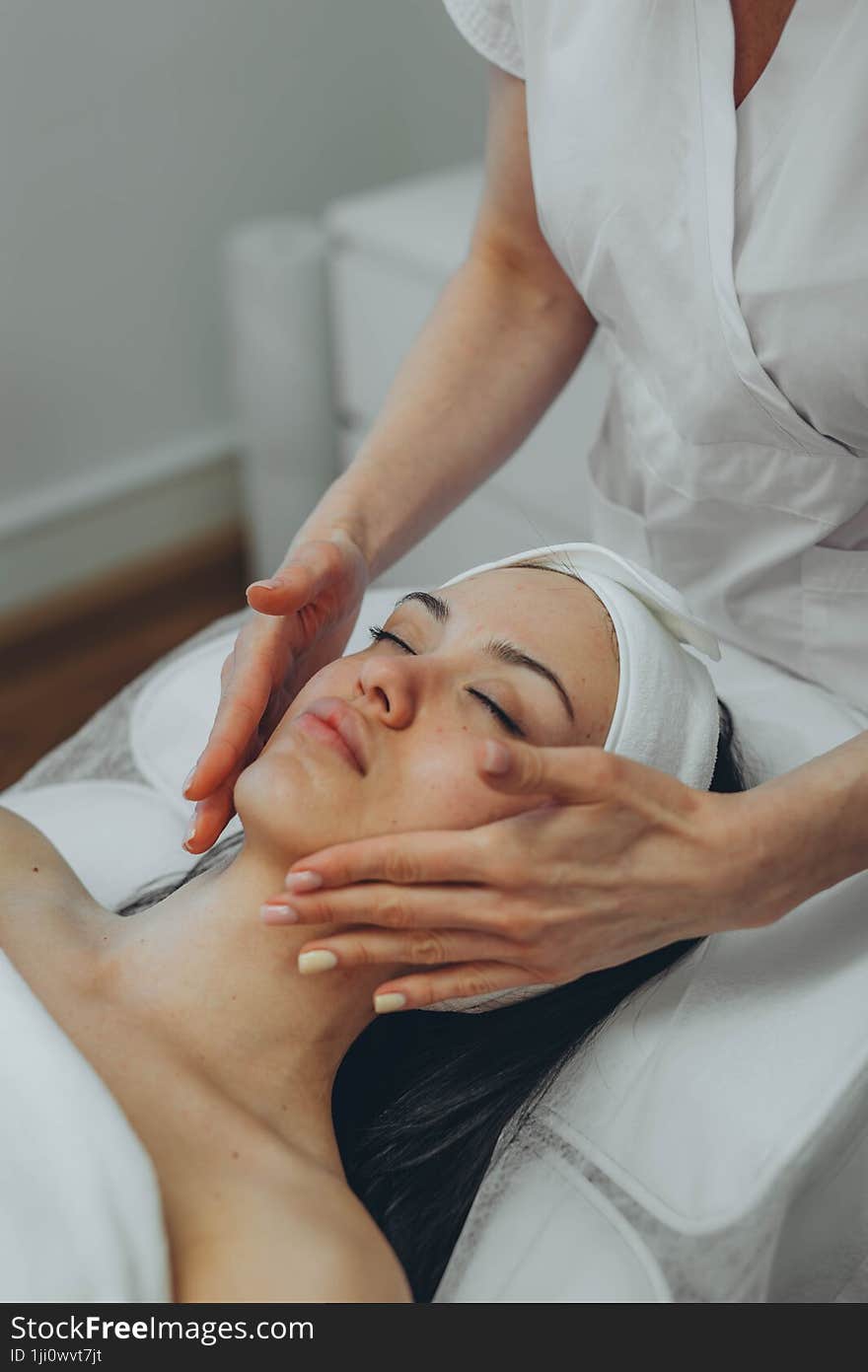 girl at a cosmetologist s office doing skin cleansing