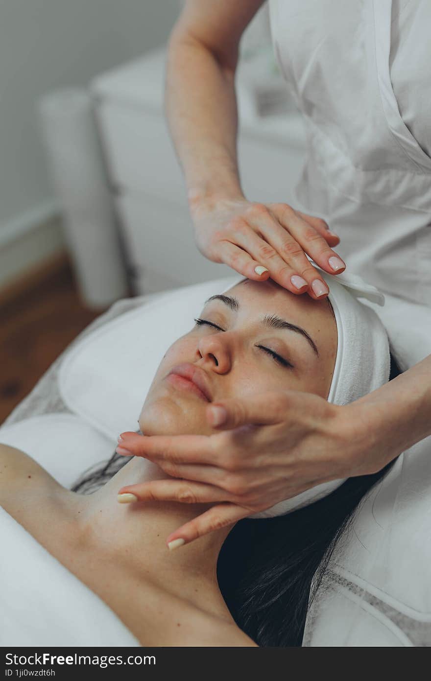 girl at a cosmetologist s office doing skin cleansing