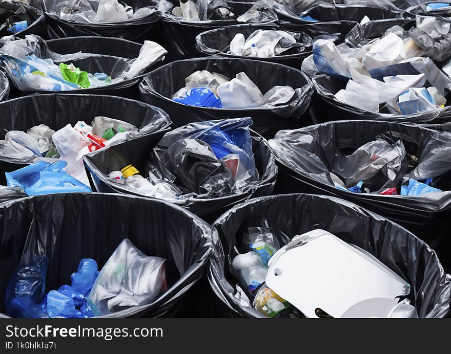 a lot of black bins filled with garbage.