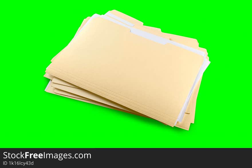 stack of yellow folders with blank labels on a green background. chroma key.