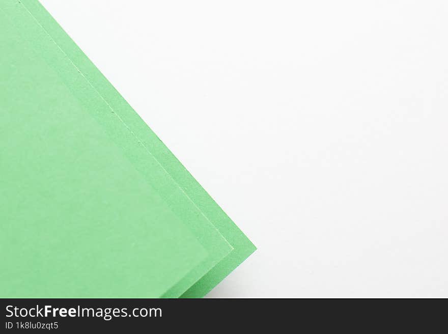 Green and white geometric colored paper background, copy space