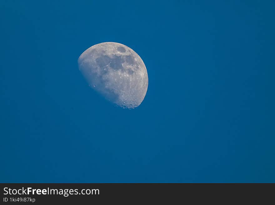 Daytime blue sky , closeup of the moon outer space