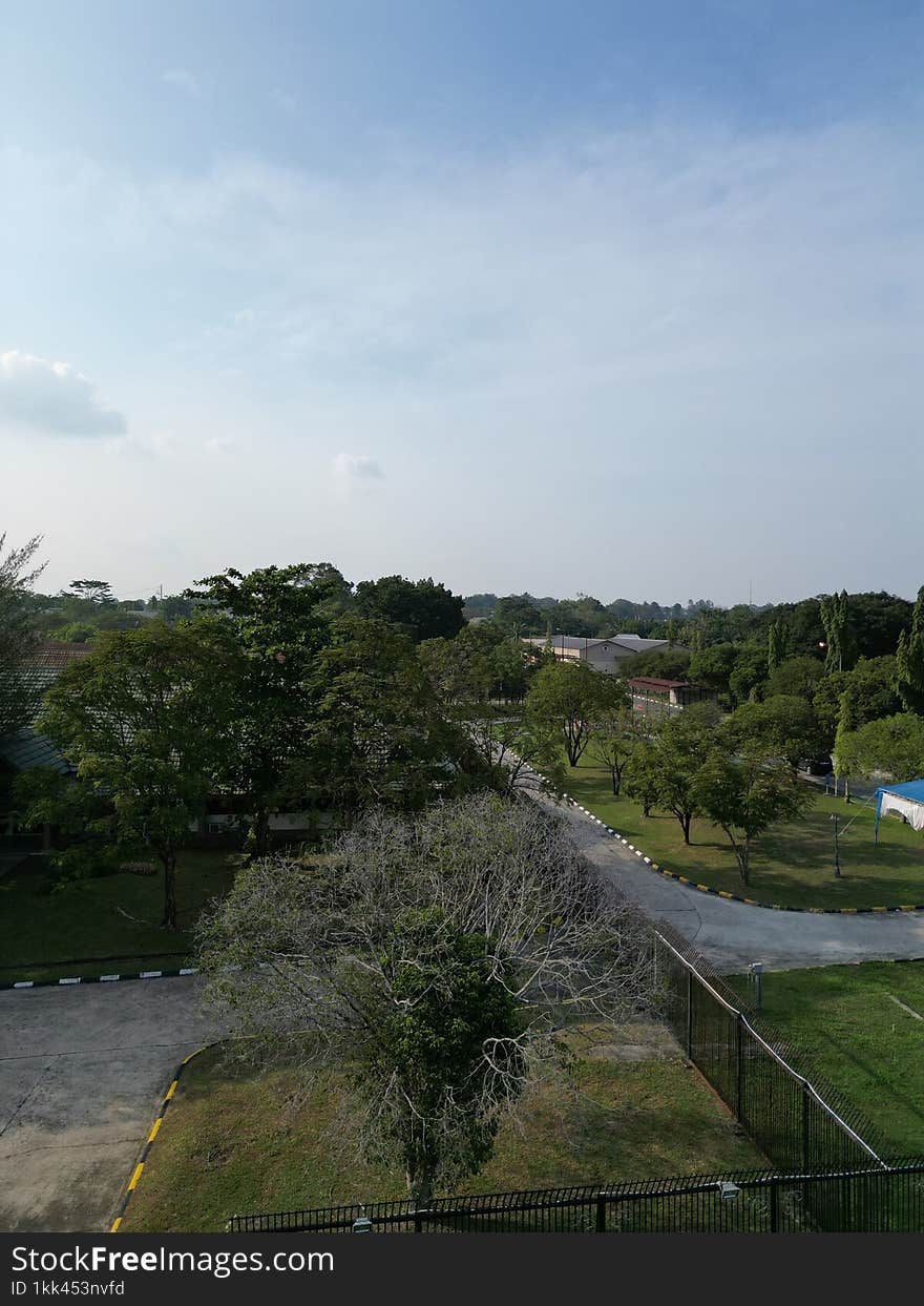 A stunning aerial photograph of Caltek Riau Park captured using a drone, showcasing the lush greenery and beautifully landscaped areas from a unique perspective.