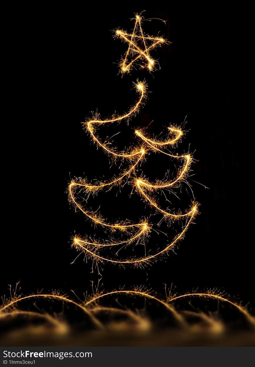 Christmas tree made by sparkler on black background