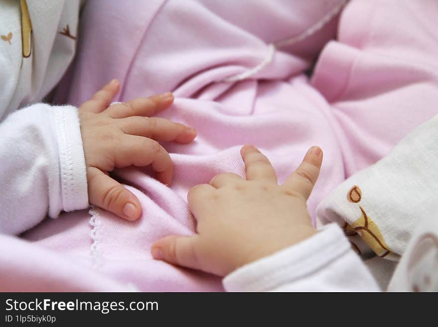 Small baby hands on pink backpack