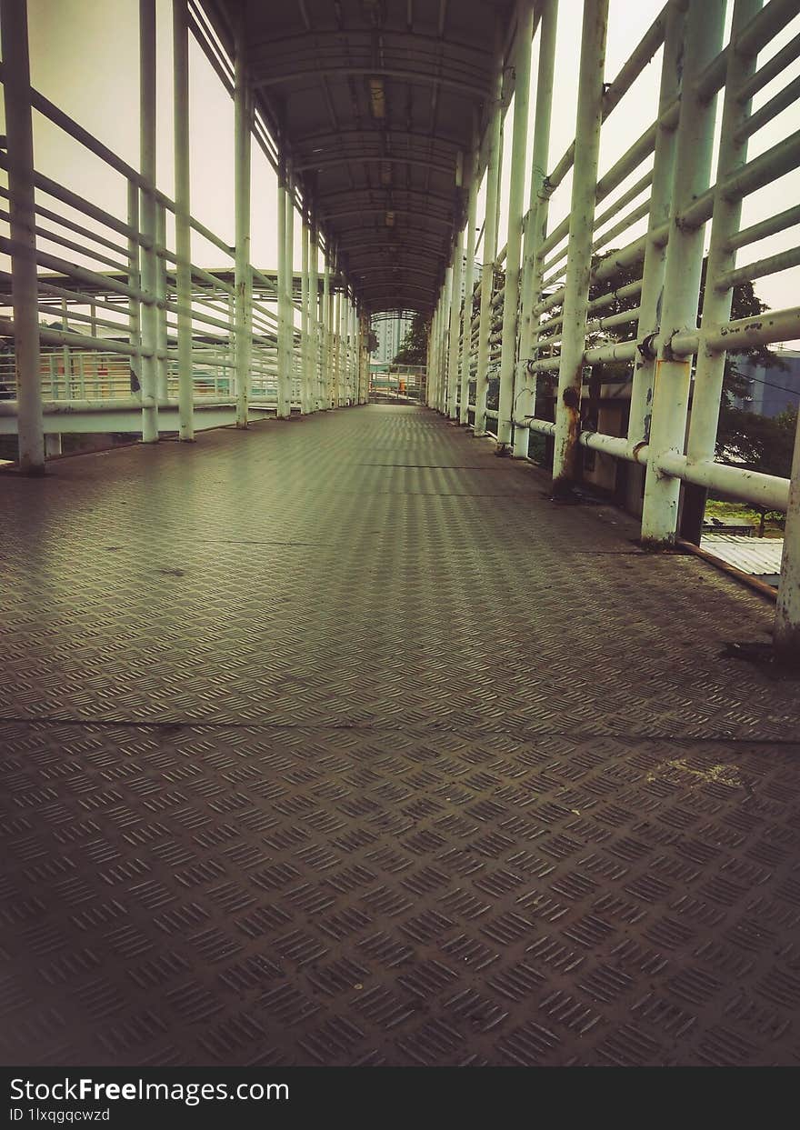 the pedestrian bridge is deserted in the late afternoon.