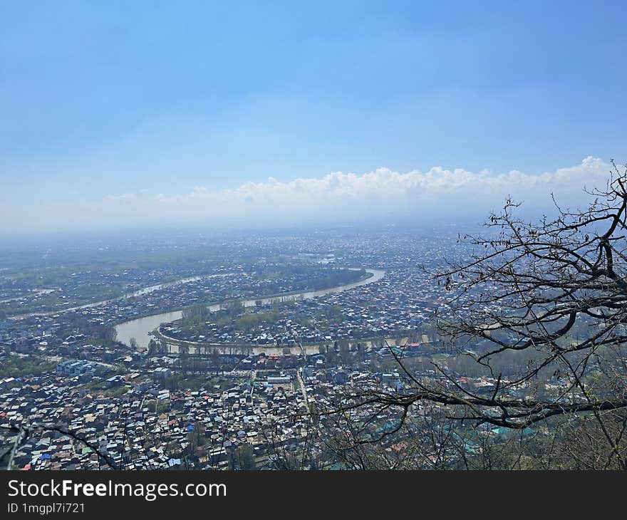 High Angle View Of Kashmir City,  Against Blue Sky And Tree, River.