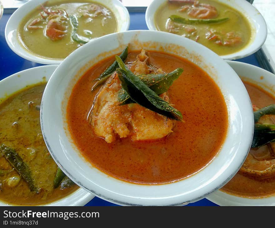 Delicious seafood curry on white plates arranged uniquely